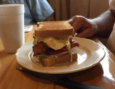 A stacked toasted sandwich with a drink