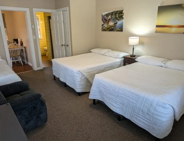 Double beds in a Double Cabin, with a doorway toward the kitchen