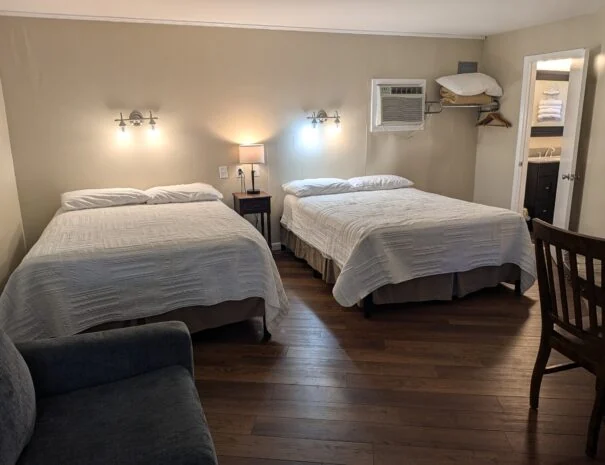 Queen beds, couch and table seating in the Premium Suite